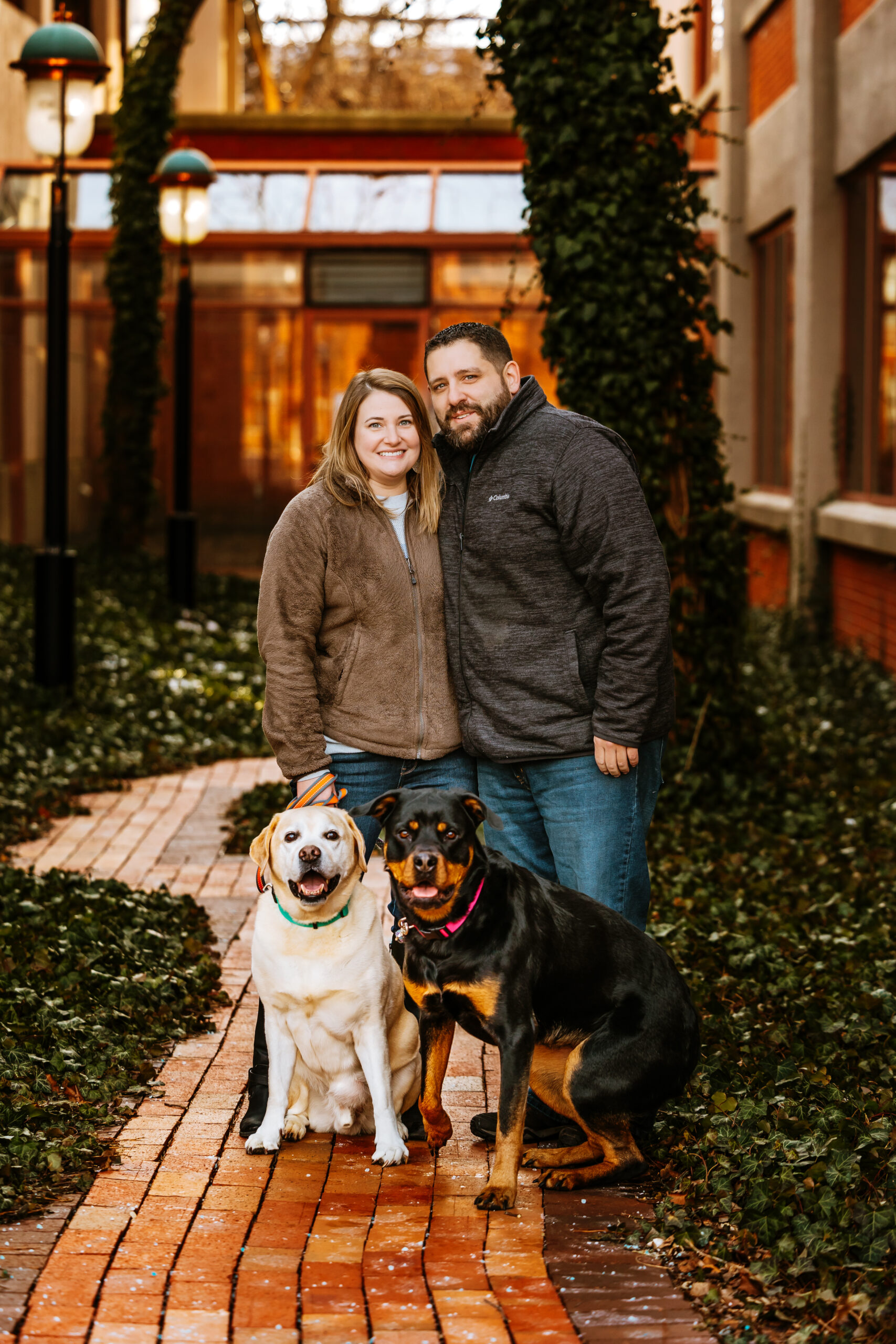 A couple with their dogs posed.